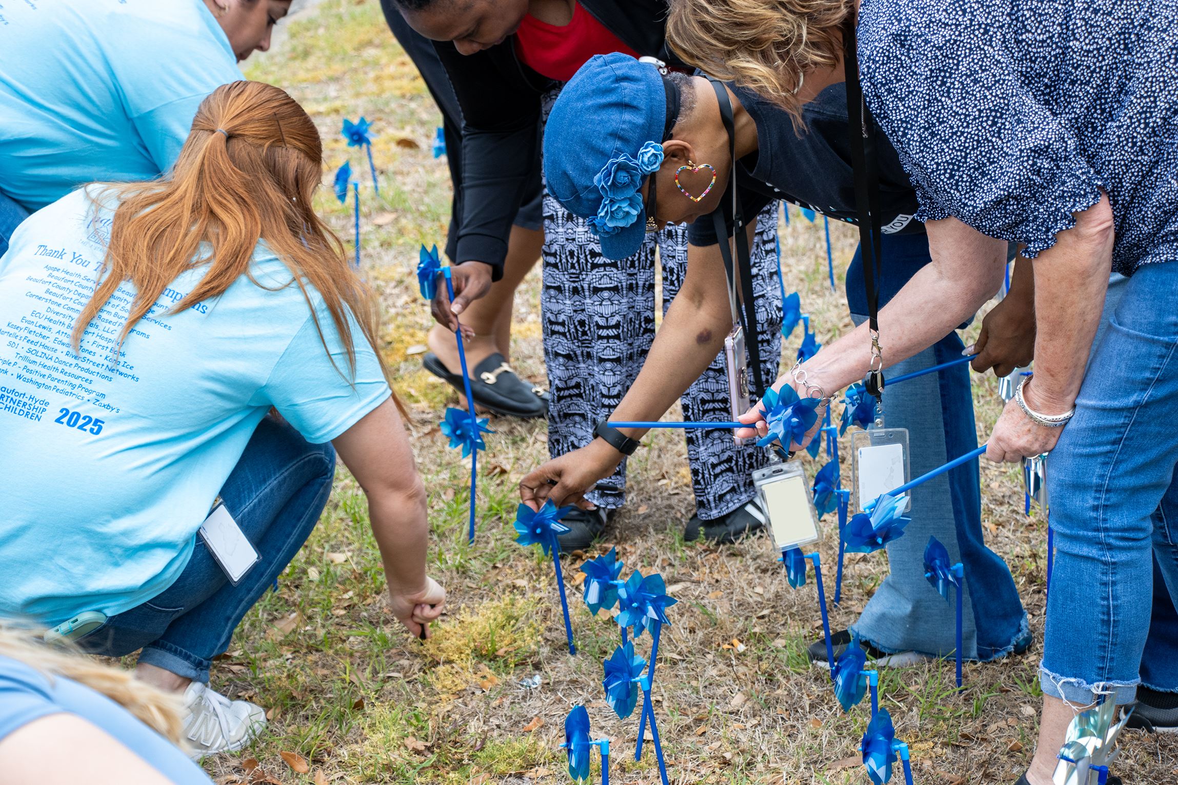 DSS employees and community partners plant a pinwheel garden on Friday, April 4, 2025.